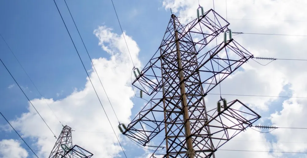 High voltage tower against the blue sky