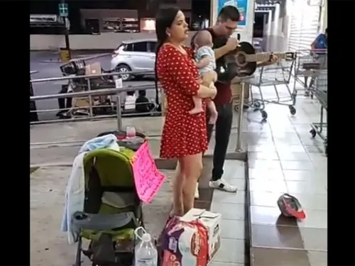 Joven pareja canta en la calle para comprar la leche de su bebé
