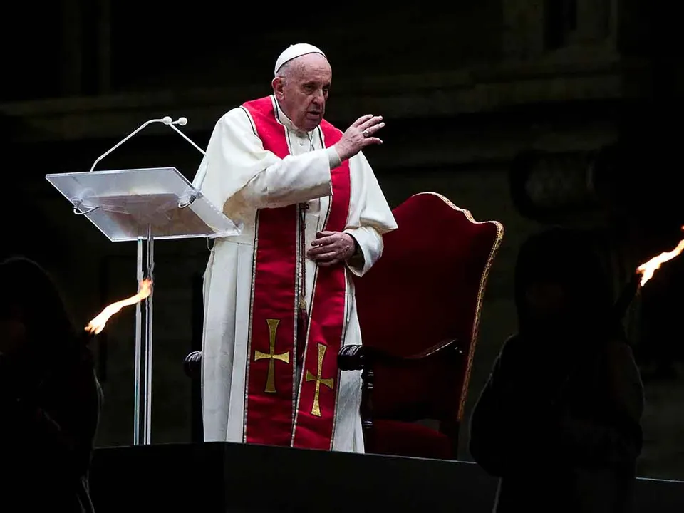Pope Francis leads the Via Crucis (Way of the Cross) procession in the empty square outside the Saint Peter’s Basilica during Good Friday celebrations at the Vatican, April 2, 2021. Angelo Carconi/Pool via REUTERS