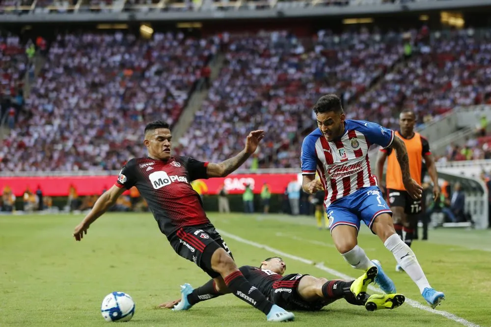 ZAPOPAN, MEXICO – SEPTEMBER 14: Ernesto Vega #07 of Chivas fights for the ball with  Anderson Santamaría #05 of Atlas during the 9th round match between Chivas and Atlas as part of the Torneo Apertura 2019 Liga MX at Akron Stadium on September 14, 2019 in Zapopan, Mexico. (Photo by Refugio Ruiz/Getty Images)